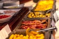 Buffet breakfast at a Chinese hotel. Closeup bacon on blurry background of food trays. Breakfast is included in the