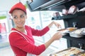 buffet female worker servicing food in cafeteria Royalty Free Stock Photo