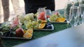 Buffet with fruits and drinks, champagne, juice. Fruit table for the holiday, Watermelon, orange and grapes. Catering