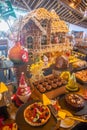 Buffet full of different kind of appetite tasty fresh made cakes and ginger house during christmas celebration