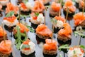 Buffet at the gala dinner. Assortment of canapes. Banquet service. catering food, snacks with salmon and caviar. rye Royalty Free Stock Photo