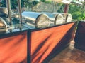 Buffet at the hotel. mini-bar with a wide selection of dishes, large cauldrons with food for tourists. wooden rack with dishes of Royalty Free Stock Photo