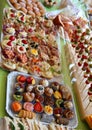 Buffet with many trays filled with sweet pastries and sandwiches