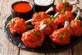 Buffet menu of Lollipops deep-fried red chicken wings served with sauces close-up on a slate board. horizontal Royalty Free Stock Photo