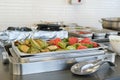 Buffet with a metal container for hot dishes with grilled zucchini and sweet peppers Royalty Free Stock Photo