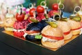 buffet with mini burgers, sliders. catering banquet table with appetizers