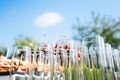 Buffet in the open air - empty glasses on the background of cold snacks against the sky Royalty Free Stock Photo