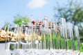 Buffet in the open air - empty glasses on the background of cold snacks against the sky Royalty Free Stock Photo