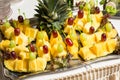 Buffet with pineapple and grapes appetizers and other fruits in restaurant Royalty Free Stock Photo
