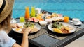 Travel woman in hat eating breakfast is served with eggs, sausage, coffee Royalty Free Stock Photo