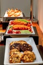 Buffet spread including grilled Reuben sandwiches under a heater Royalty Free Stock Photo