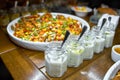 Buffet table with Bruschetta, Appetizers and different sauces. with hummus, beef, pate, avocado, tomatoes. on a wooden rustic tabl