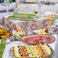 Buffet table full of food in small dishes, sweets and a fruit platter. Royalty Free Stock Photo