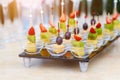 Buffet at the wedding Banquet. Glasses of wine and champagne. Assortment of fruit canapes on a glass Board. Banquet Royalty Free Stock Photo