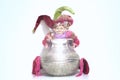 Buffoon toy holding silver shining jug