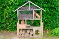 Bug hotel wood insect house ladybird wooden bee home in ecological gardening concept Royalty Free Stock Photo