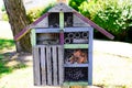 Bug hotel wooden insect house ladybird bee home in ecological gardening concept Royalty Free Stock Photo