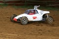 Buggy on track going fast and throwing dirt in the air Royalty Free Stock Photo