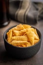 Bugles snack. Cone corn chips in bowl on kitchen table Royalty Free Stock Photo