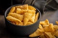 Bugles snack. Cone corn chips in bowl on kitchen table Royalty Free Stock Photo