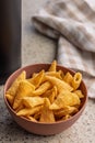 Bugles snack. Cone corn chips in bowl on kitchen table Royalty Free Stock Photo