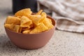 Bugles snack. Cone corn chips in bowl on kitchen table Royalty Free Stock Photo