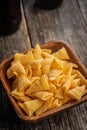Bugles snack. Cone corn chips in bowl on wooden table Royalty Free Stock Photo
