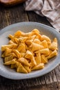 Bugles snack. Cone corn chips in bowl on wooden table Royalty Free Stock Photo