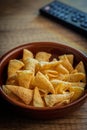 Bugles snack. Cone corn chips in bowl on wooden table Royalty Free Stock Photo