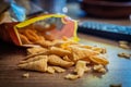 Bugles snack. Cone corn chips on wooden table Royalty Free Stock Photo