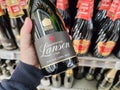 Closeup of Man hand buying a bottle of Lanson brand champagne, a major French brand producing traditional French champagne Royalty Free Stock Photo
