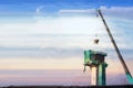 Build a bridge using a crane to lift concrete on a construction site