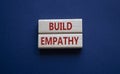 Build empathy symbol. Wooden blocks with words Build empathy. Beautiful deep blue background. Psychology and Build empathy concept Royalty Free Stock Photo