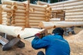 Build a house from logs. Preparation of logs for the assembly of the structure. Assembly of a wooden log house at a Royalty Free Stock Photo