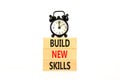 Build new skills symbol. Concept word Build new skills on beautiful wooden block. Black alarm clock. Beautiful white table white Royalty Free Stock Photo