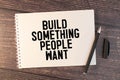 Build something people want. text on white notepad on craft background Royalty Free Stock Photo