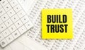 BUILD TRUST Concept. Calculator,pen and glasses on the white background Royalty Free Stock Photo