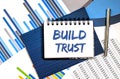 BUILD TRUST Concepts on the notepad with pen and charts Royalty Free Stock Photo