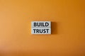 Build trust symbol. Wooden blocks with words Build trust. Beautiful orange background. Business and Build trust concept. Copy
