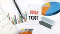 BUILD TRUST text on note paper on chart background Royalty Free Stock Photo