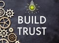 BUILD TRUST text on a notebook with calculator on diagram background Royalty Free Stock Photo