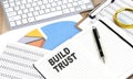 BUILD TRUST text on a paper on chart background Royalty Free Stock Photo