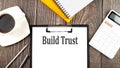 BUILD TRUST text on paper with coffee, calculator and notebook. Business concept Royalty Free Stock Photo
