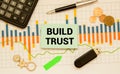 BUILD TRUST text on sticker with calculator, glasses and magnifier. Royalty Free Stock Photo