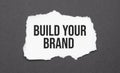 Build Your Brand sign on the torn paper on the black background Royalty Free Stock Photo