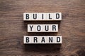 Build your brand - word concept on building blocks, text Royalty Free Stock Photo