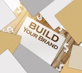 Build Your Own Brand words on a page and paper dollar signs around on wooden table. Branding rebranding marketing