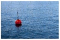 Build your security step by step - Concept image, with red bouy on a calm lake, in jigsaw puzzle shape Royalty Free Stock Photo