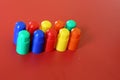 Buildable colored plastic blocks to play, build and organize on a red background as a concept of inclusion, diversity and pluralit Royalty Free Stock Photo