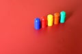 Buildable colored plastic blocks to play, build and organize on a red background as a concept of inclusion, diversity and pluralit Royalty Free Stock Photo